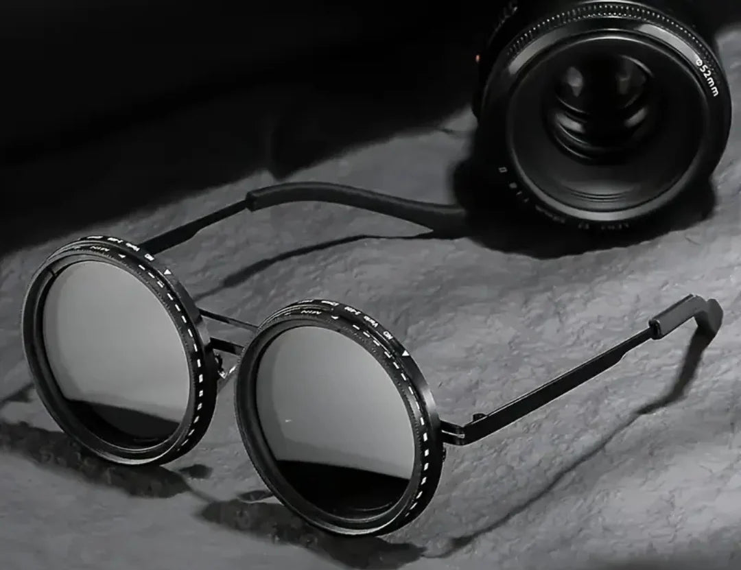 Round sunglasses with metallic frame on a textured surface